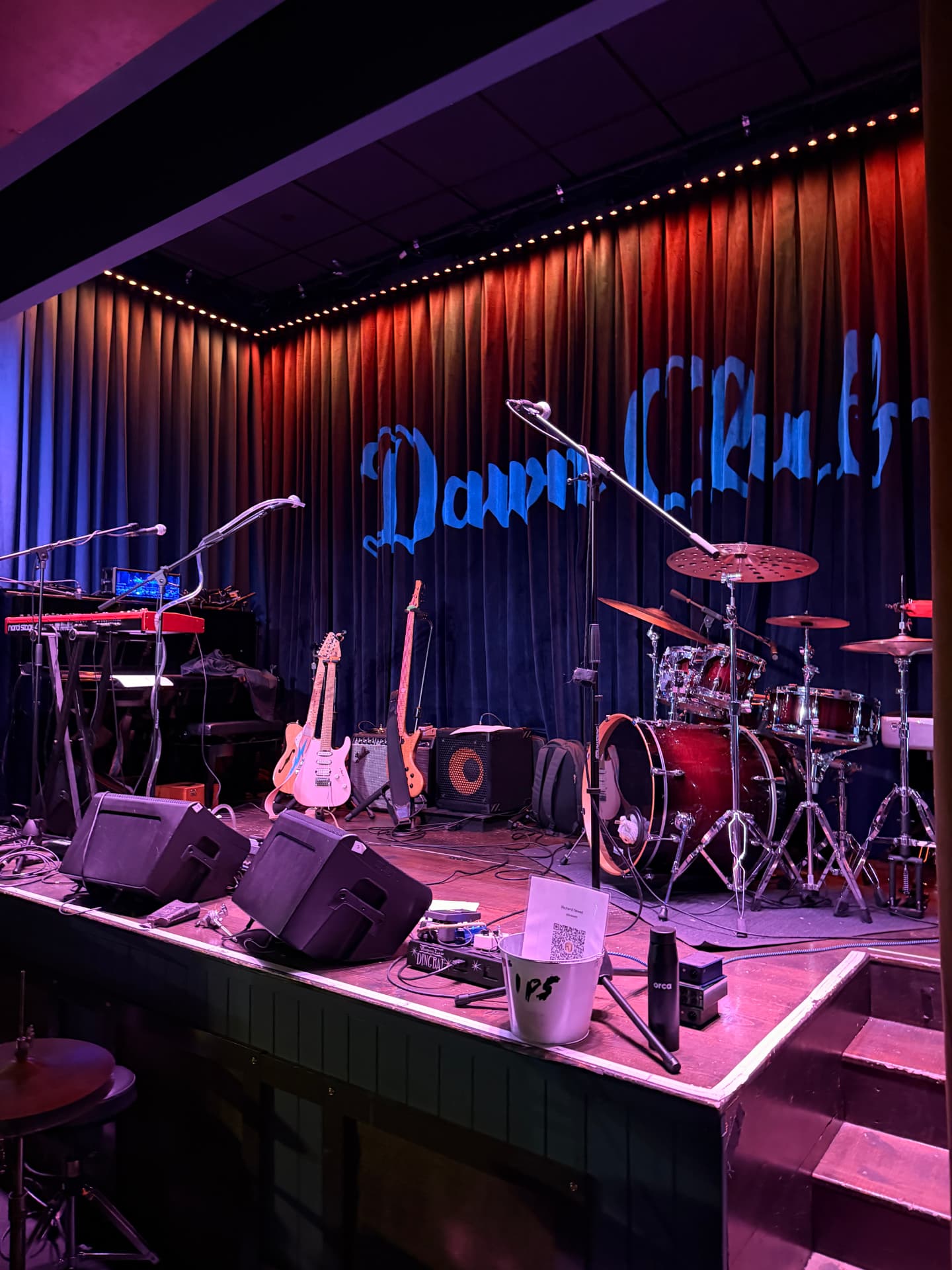 Keys, guitars and drum kit ready on stage